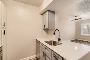 Haltom City apartment for rent - A kitchen with a sink and a fan.