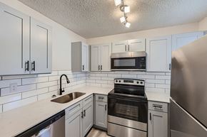 Arlington apartment for rent - A kitchen with white cabinets and a stainless steel refrigerator.