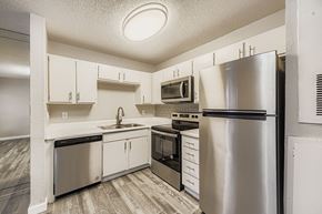 Arlington apartment for rent - A swimming pool surrounded by a fence and trees.