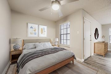 Arlington apartment for rent - A modern living room with a black couch and a TV on the wall.