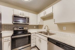 Arlington apartment for rent - A dining room with a table set for two and a view of the outdoors through the sliding glass doors.