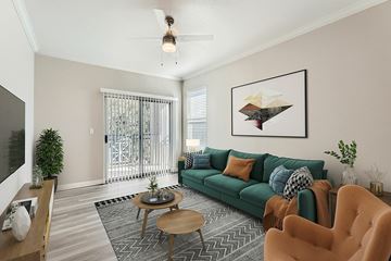 Dallas apartment for rent - A living room with a green couch and a coffee table.