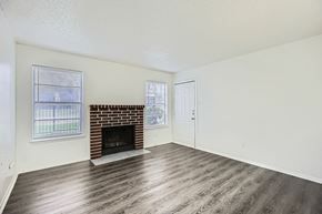 Dallas apartment for rent - A room with a fireplace and a window.