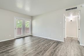 Dallas apartment for rent - A room with a sliding glass door and a white door.