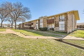Dallas apartment for rent - Apartment complex with a grassy area in front.