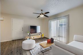 Garland apartment for rent - A bedroom with a large bed and a ceiling fan.