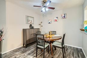 Fort Worth apartment for rent - A dining room with a table set for two and a ceiling fan.