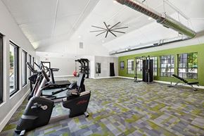 Greensboro apartment for rent - A gym with a variety of equipment including treadmills, weights, and a bench press.