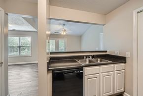 Charlotte apartment for rent - A kitchen with a black dishwasher and white cabinets.
