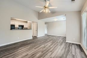 Charlotte apartment for rent - A spacious room with a ceiling fan and lighting fixture.