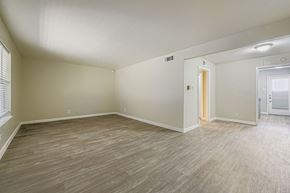 Fort Worth apartment for rent - A room with light wood flooring and white walls.