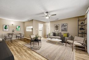 Charlotte apartment for rent - A kitchen with white cabinets and a black stove top oven.