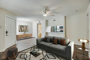 Garland apartment for rent - A spacious room with a ceiling fan and wooden flooring.