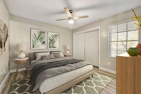 Garland apartment for rent - A bedroom with a bed, nightstands, and a ceiling fan.