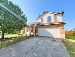 Killeen house for rent - A house with a white garage door and a brown roof.