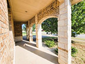 Killeen house for rent - A long corridor with arches and a grassy area on the side.
