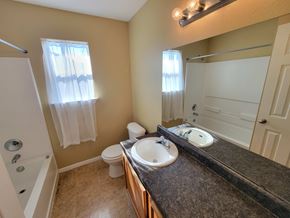 Killeen house for rent - A bathroom with a sink, toilet, and bathtub.