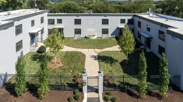 Nashville apartment for rent - A courtyard surrounded by buildings with a black fence.