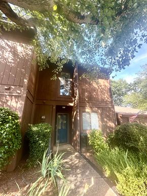 Simpsonville house for rent - A tree branch is hanging over a building with a blue door.