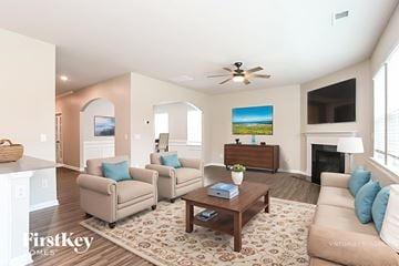 Troutman house for rent - A living room with a fireplace and a painting of a beach scene on the wall.