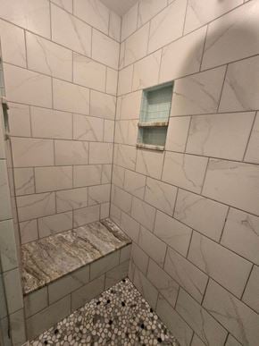Baltimore house for rent - A bathroom with a marble tile shower and a window.