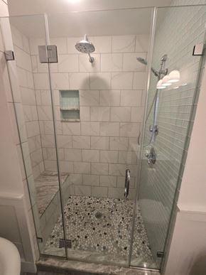 Baltimore house for rent - A shower with a glass door and a glass shelf.