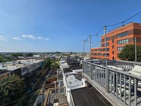 Baltimore house for rent - A bridge over a river with a building on the right.