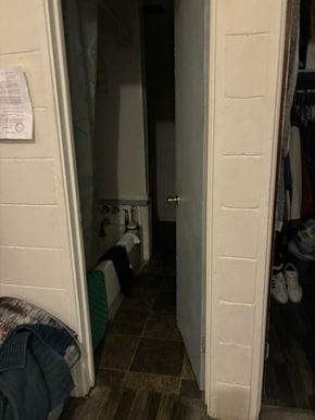 Prentiss apartment for rent - A white door is open to a dark hallway.
