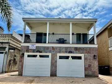 Newport Beach apartment for rent - A two-car garage is attached to a house.