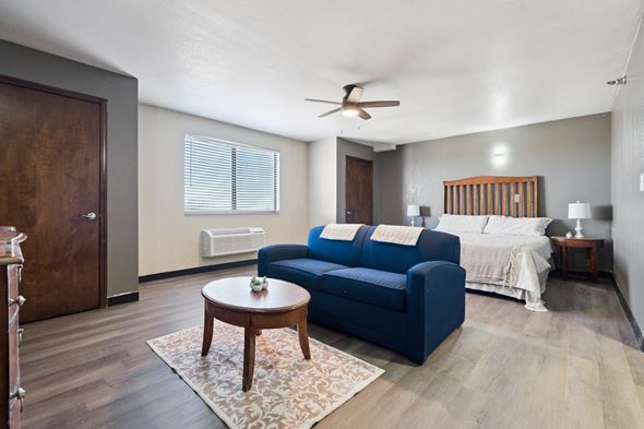 Edmond apartment for rent - A blue couch sits in a living room with a wooden coffee table in front of it.