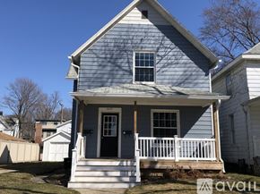 St. Joseph apartment for rent - A blue house with a white porch and a black door.