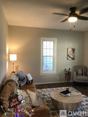 St. Joseph apartment for rent - A living room with a couch, a coffee table, and a ceiling fan.