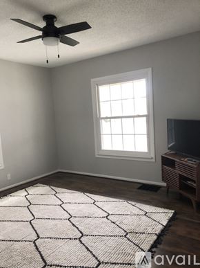 St. Joseph apartment for rent - A room with a ceiling fan, a window, and a rug on the floor.