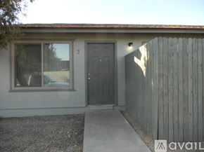 Phoenix house for rent - A house with a grey door and a grey fence.