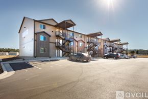 Summerset apartment for rent - A sunny day at a modern apartment complex with cars parked in the lot.