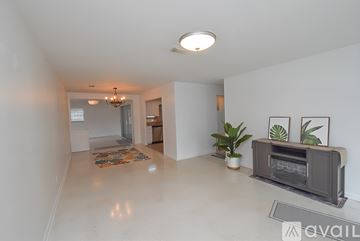 St. Augustine house for rent - A spacious living room with a grey sofa and a chandelier.