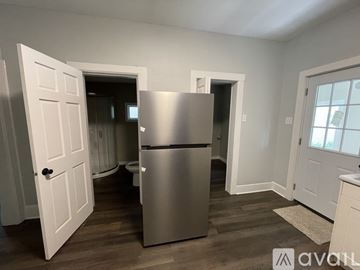 Rock Island house for rent - A kitchen with a stainless steel refrigerator and white doors.