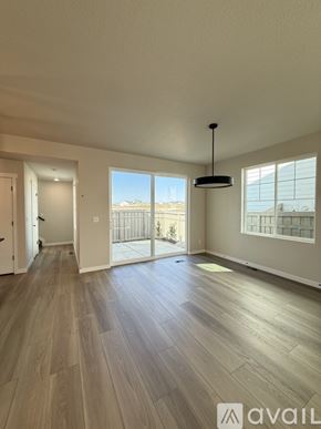 Colorado Springs house for rent - A modern kitchen with a center island and dark brown cabinets.