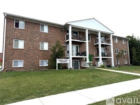 Petoskey apartment for rent - A red brick building with white trim and balconies.