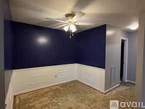 Petoskey apartment for rent - A room with a carpeted floor and a ceiling fan.