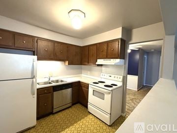 Petoskey apartment for rent - A kitchen with a white refrigerator, white stove, and yellow tiled floor.