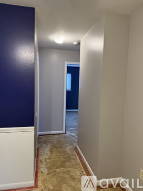 Petoskey apartment for rent - A room with a carpeted floor and a brown door.
