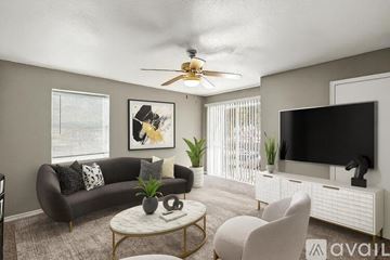 Fort Worth apartment for rent - A kitchen with black cabinets and a black fridge.