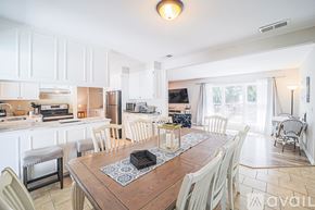 Hilton Head Island house for rent - A kitchen with a table and chairs in the foreground.