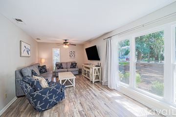 Hilton Head Island house for rent - A living room with a grey couch and a black and white patterned sofa.