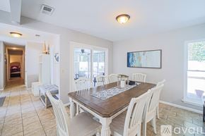 Hilton Head Island house for rent - A dining room with a wooden table surrounded by white chairs.
