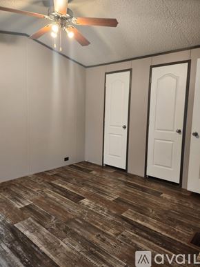 Odessa house for rent - A room with a ceiling fan and wooden flooring.