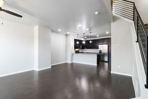Parker house for rent - A spacious living room with a staircase on the right side.
