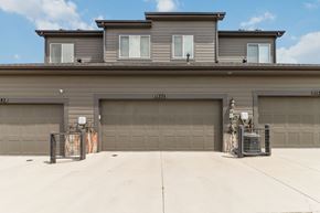 Parker house for rent - A grey building with a garage door and a sign that reads "UL1574".