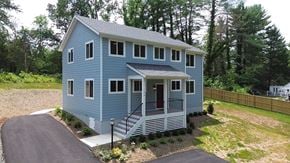 Charlottesville house for rent - A blue house with a red door and a small porch.